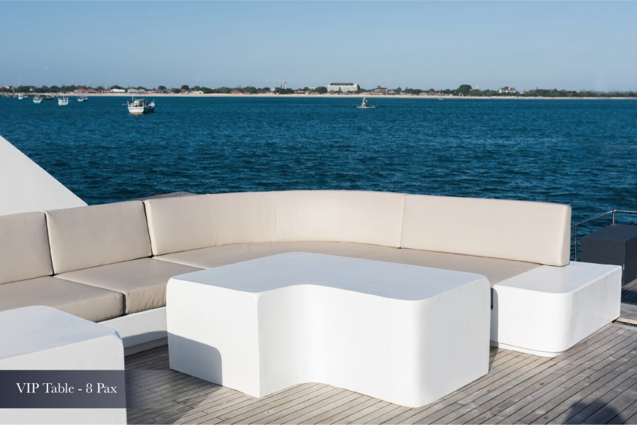 White VIP lounge sofa and table on deck overlooking the Nusa Dua bay