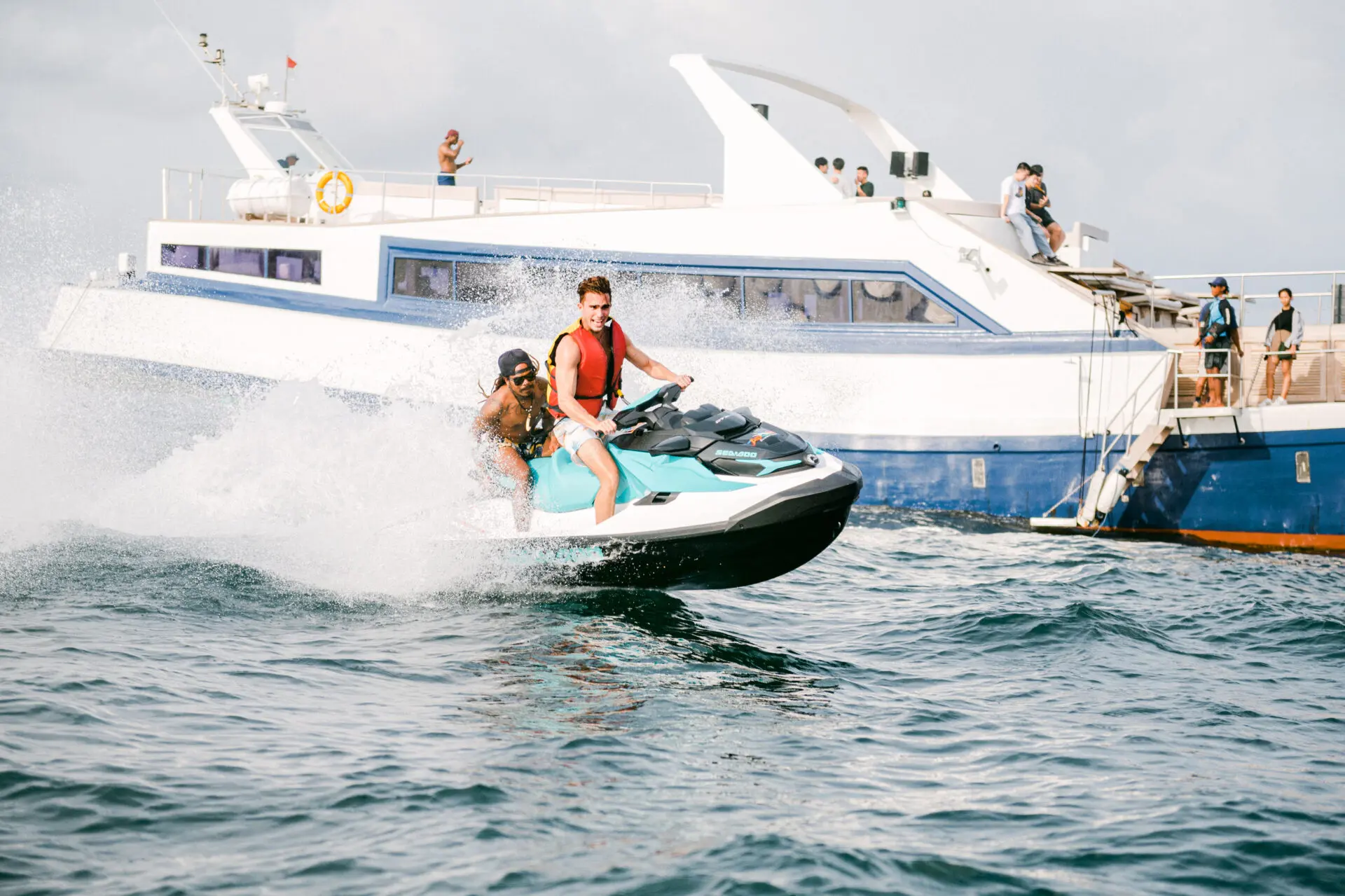 two men riding jet ski