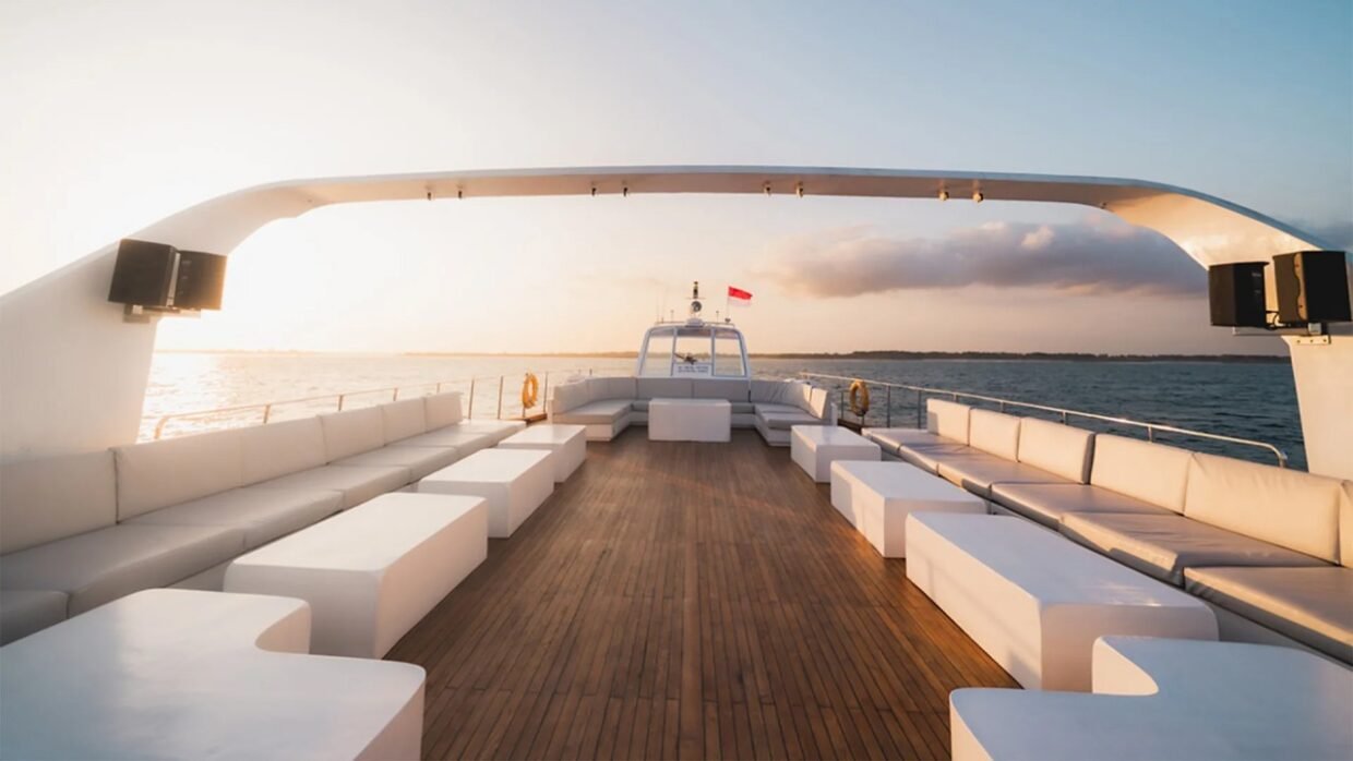 Open deck of the Shivanna luxury yacht with ocean views at sunset