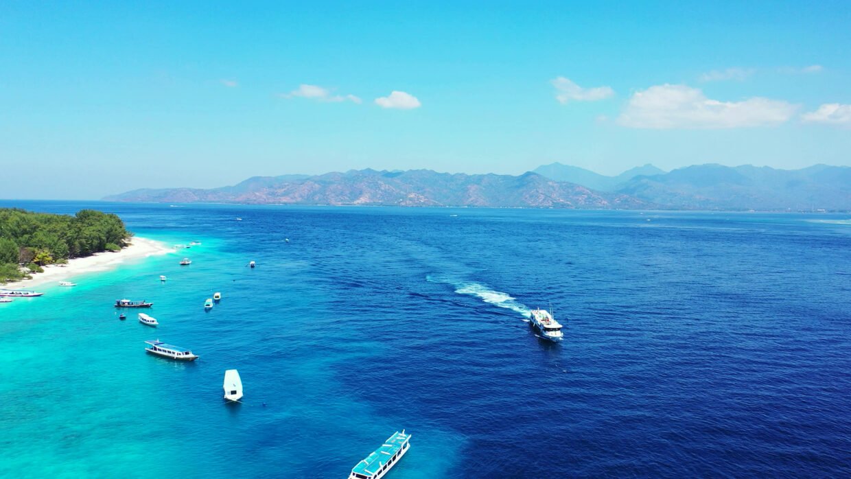 Yachts cruising in the clear waters of Bali