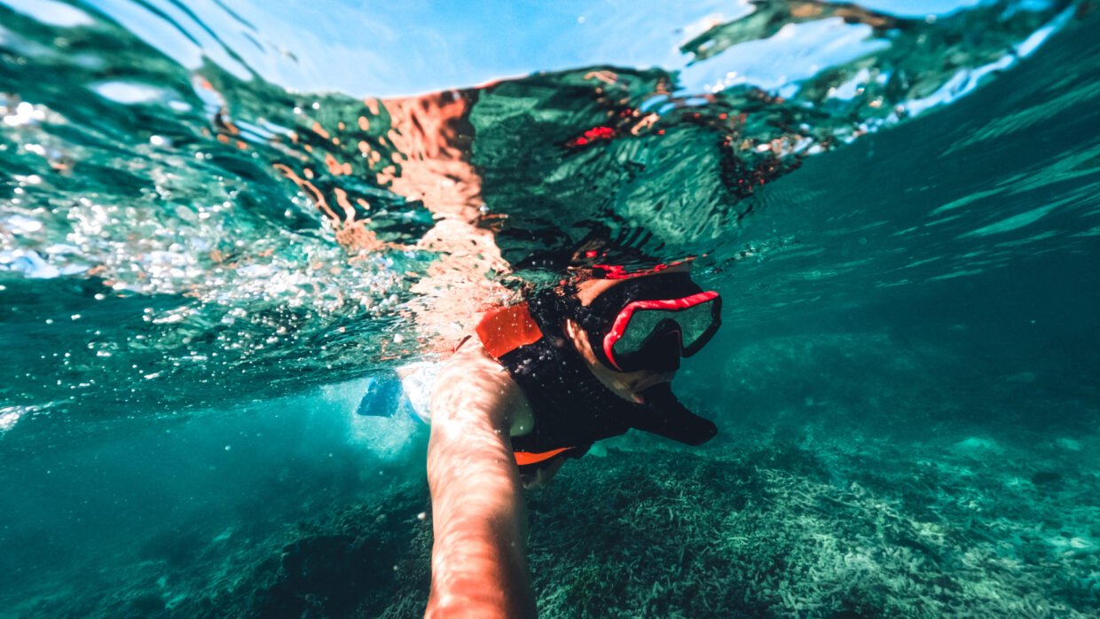 Traveler snorkeling in Bali's clear waters