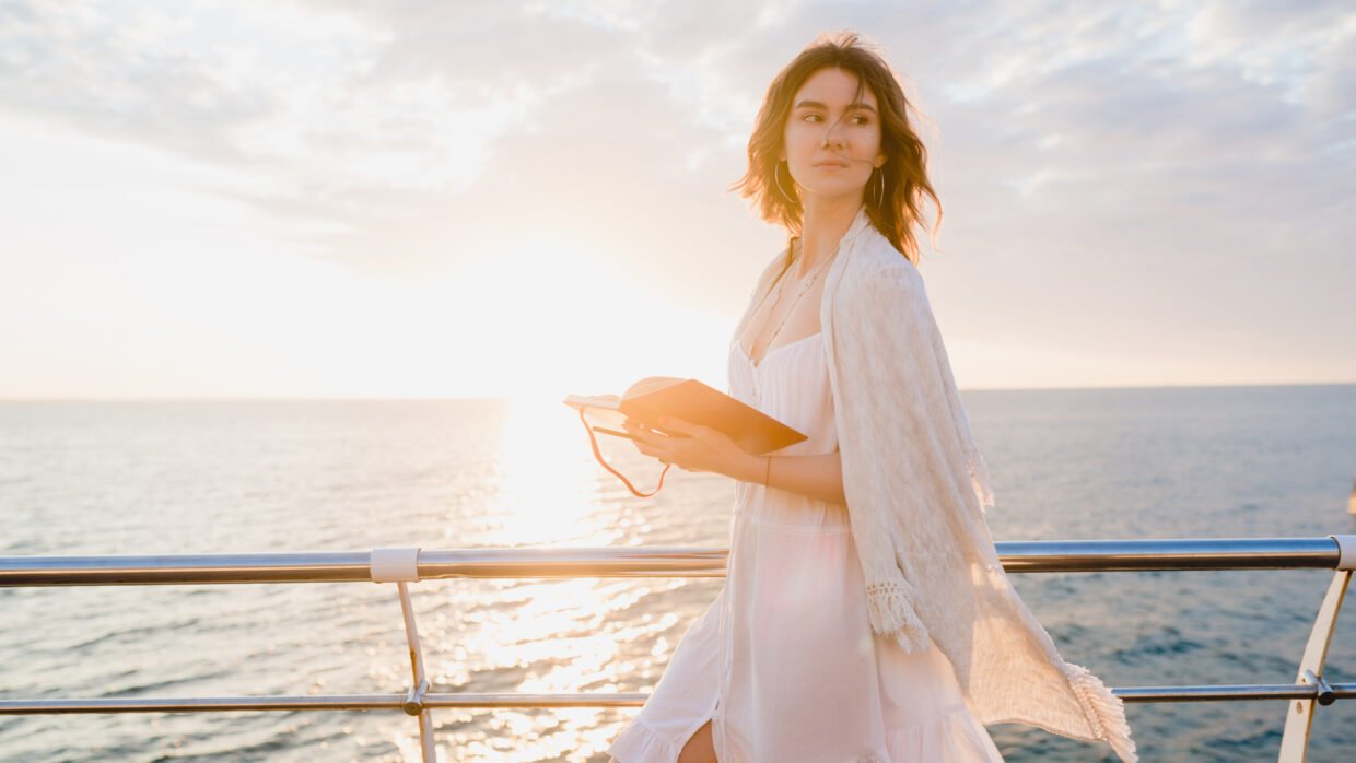 Woman wearing a light outfit on a sunset yacht cruise